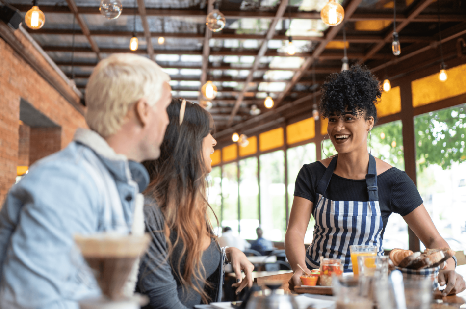 A group of people sitting at tables in a restaurant.