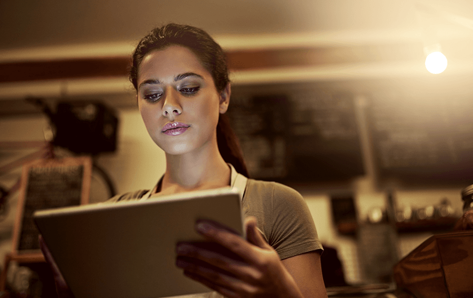 A woman is looking at her tablet