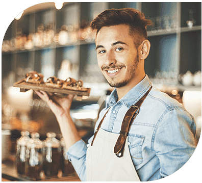 A man holding a tray of food in his hand.