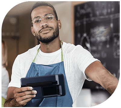 A man holding an electronic device in his hand.