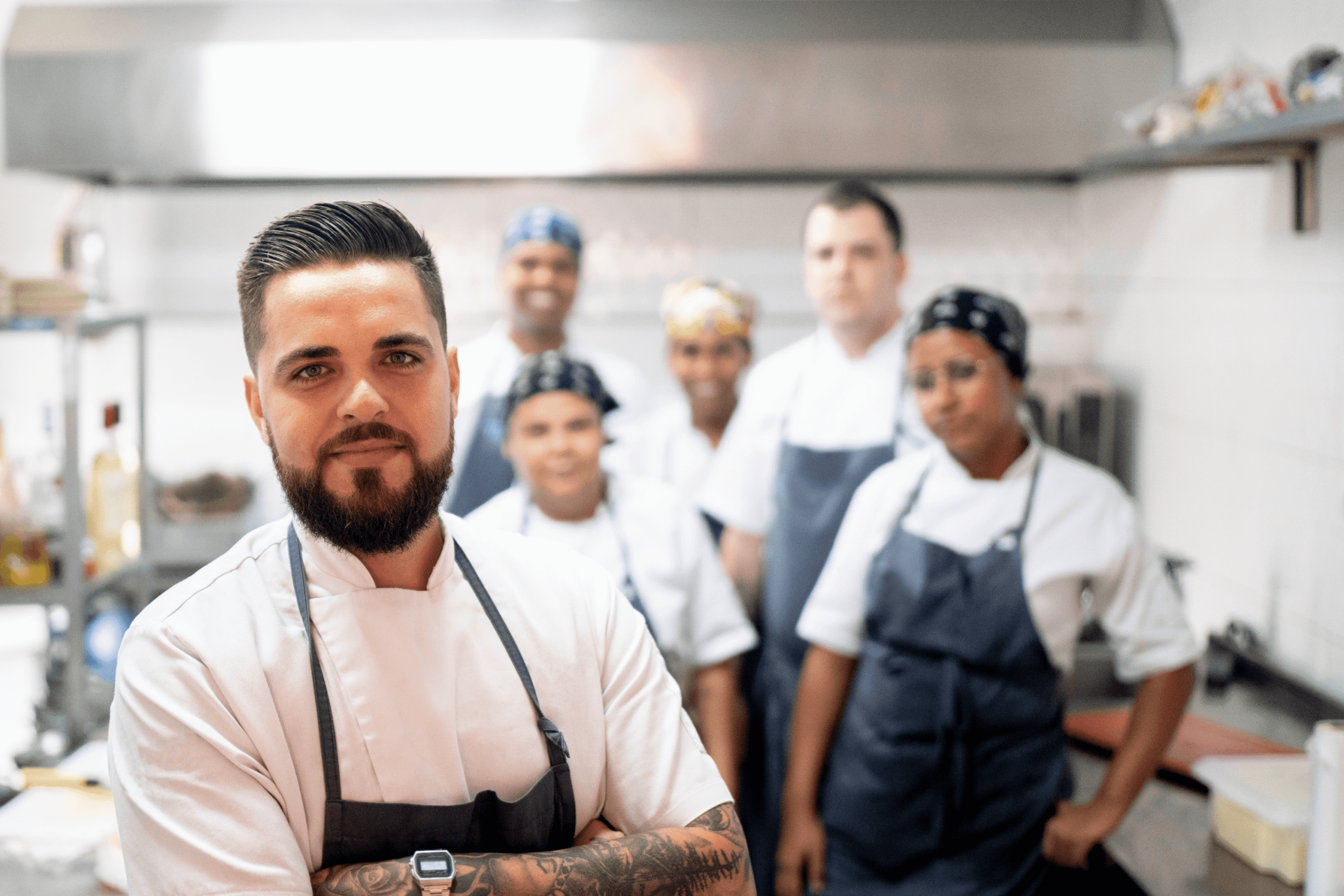 Chef and team in a professional kitchen.