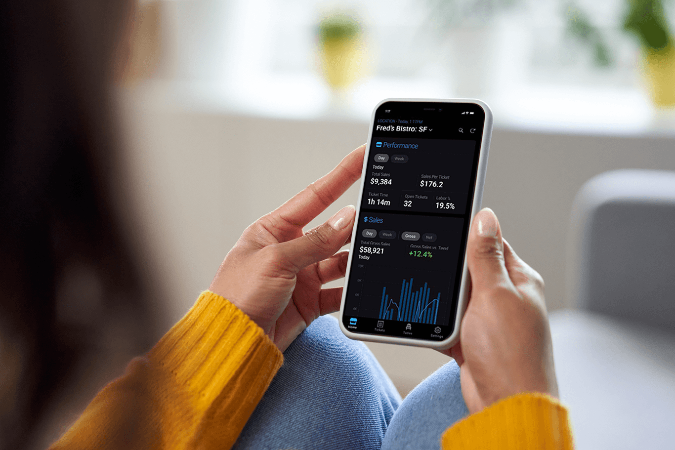 Person checking stock performance on smartphone app.