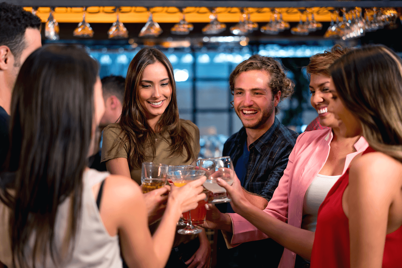 Group of friends toasting at a bar.