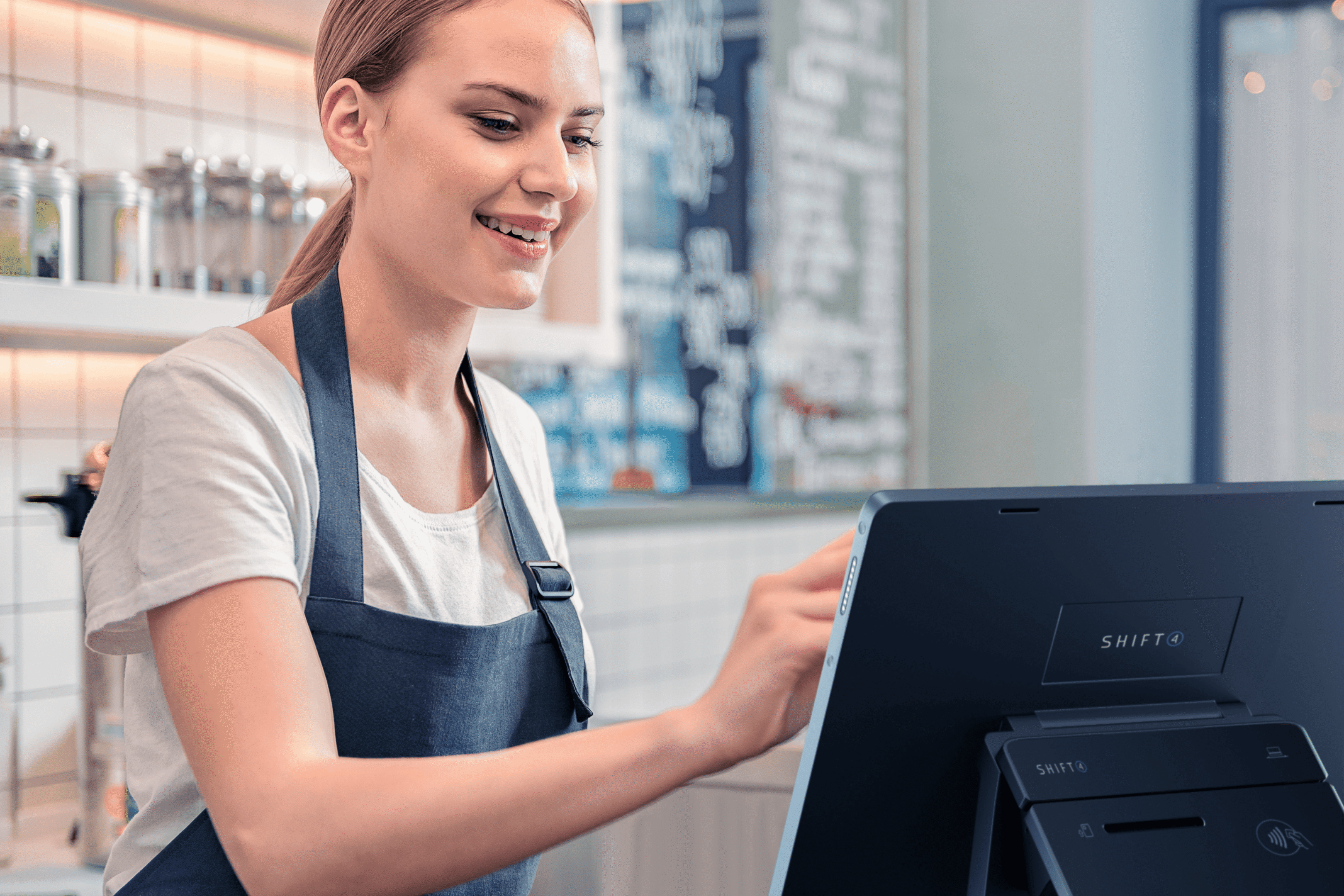 Barista using touchscreen in a café.